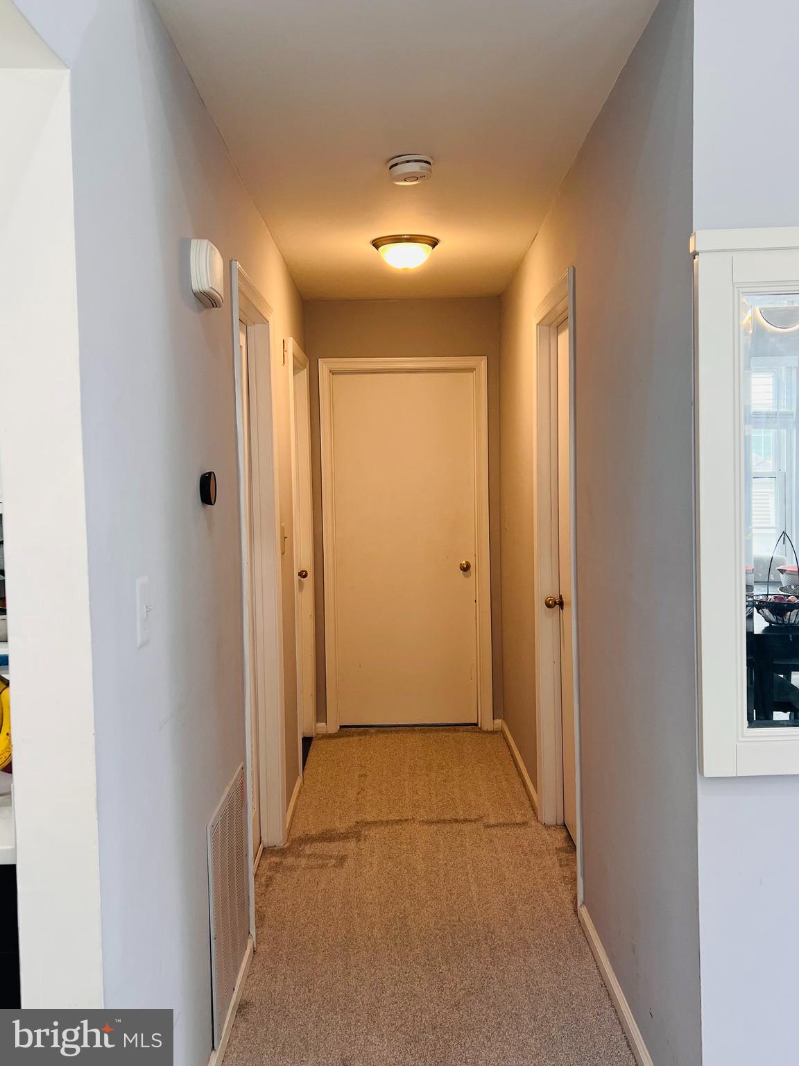 23 Powell Court Hightstown, NJ 08520 - Photo 14 of 31 a view of a hallway with wooden shelves