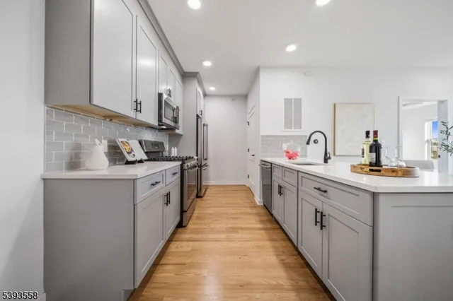 a large kitchen with stainless steel appliances lots of counter space and a sink