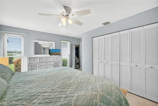 a large bedroom with a large bed and a chandelier