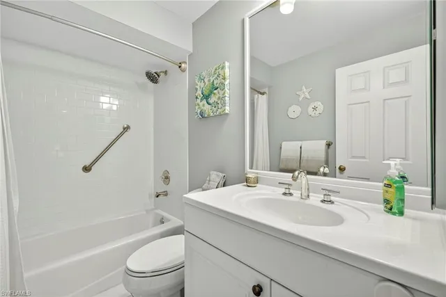 a bathroom with a sink a toilet a tub and shower