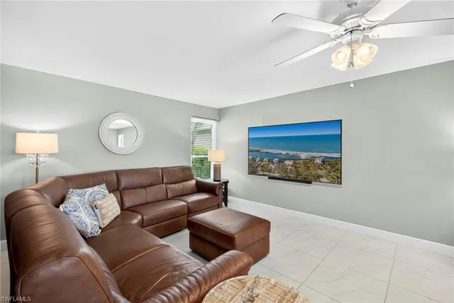 a living room with furniture a rug and a window