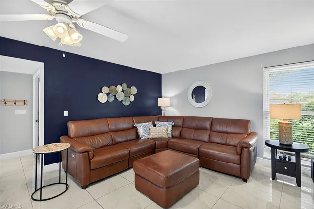 a living room with furniture a chandelier and a window