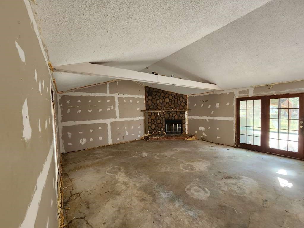 422 Texla Road Vidor, TX 77662 - Photo 3 of 9 an empty room with a fireplace and windows