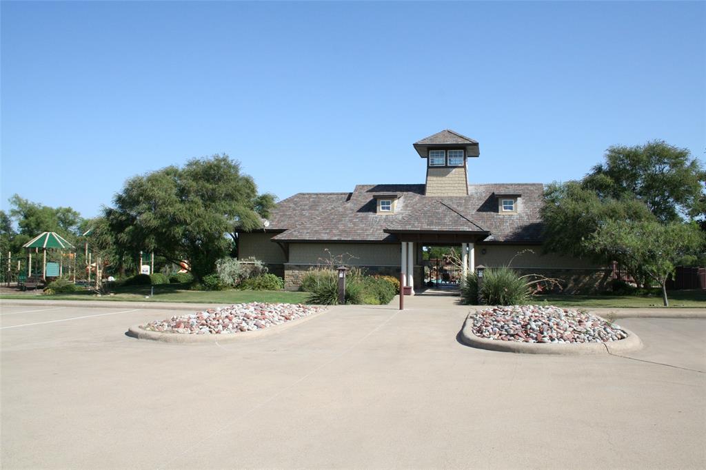 7721 Prestwick Drive Cleburne, TX 76033 - Photo 7 of 8 a front view of a house with a yard and garage