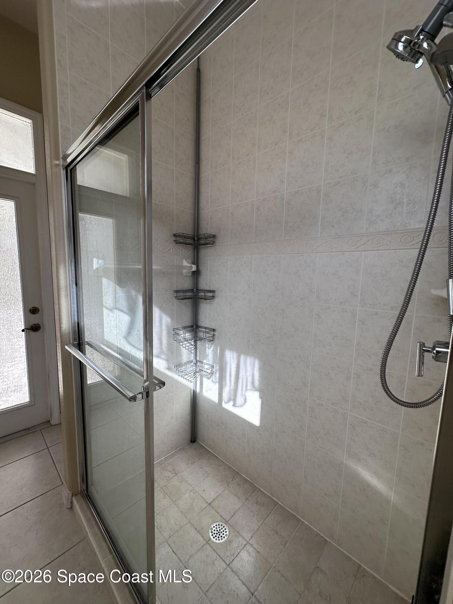 883 Spring Oak Drive Melbourne, FL 32901 - Photo 29 of 45 a bathroom with a glass shower door