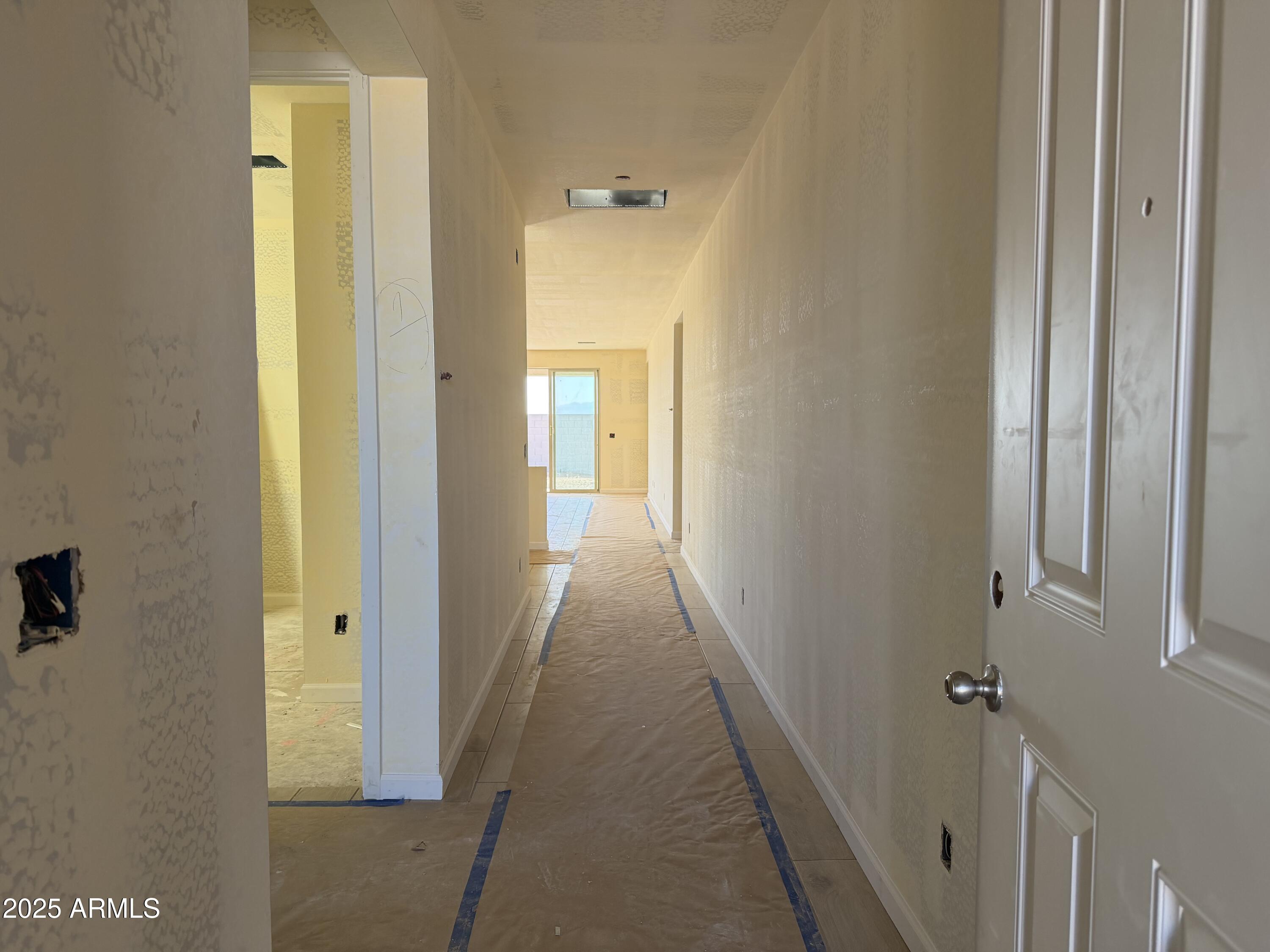 5609 West Hopi Trail Laveen, AZ 85339 - Photo 3 of 29 a view of a hallway with wooden floor and a bathroom
