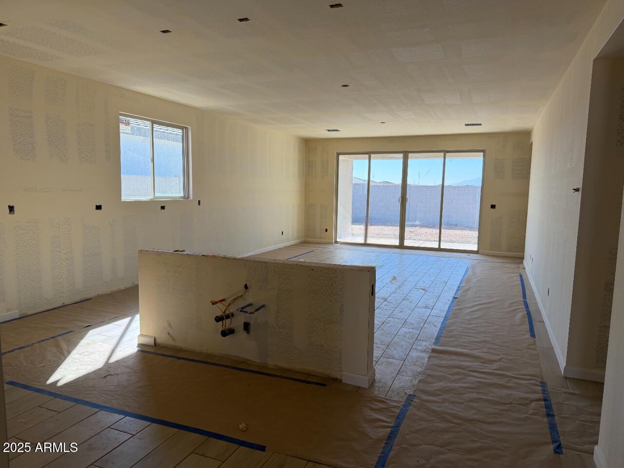 5609 West Hopi Trail Laveen, AZ 85339 - Photo 4 of 29 an empty room with wooden floor and windows