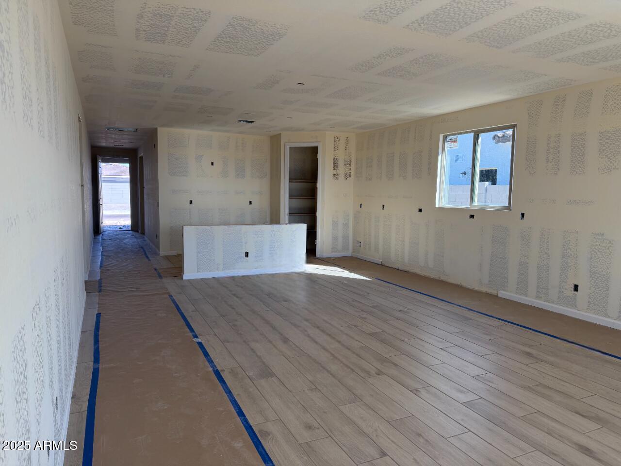 5609 West Hopi Trail Laveen, AZ 85339 - Photo 8 of 29 wooden floor in an empty room with a window