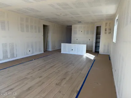 a view of a room with wooden floor