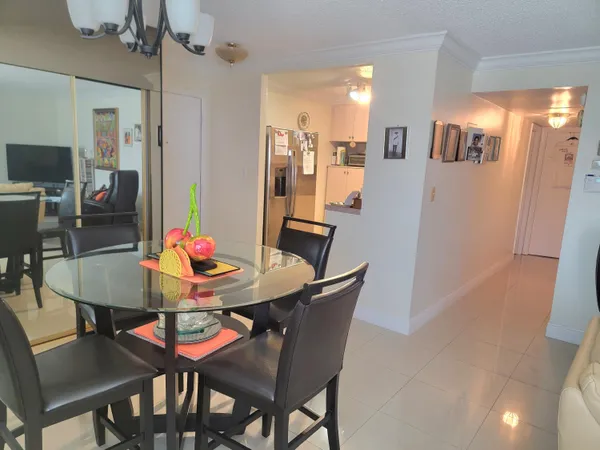 a view of a dining room with furniture and a chandelier