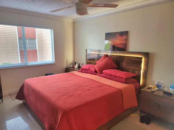a bedroom with a bed and window