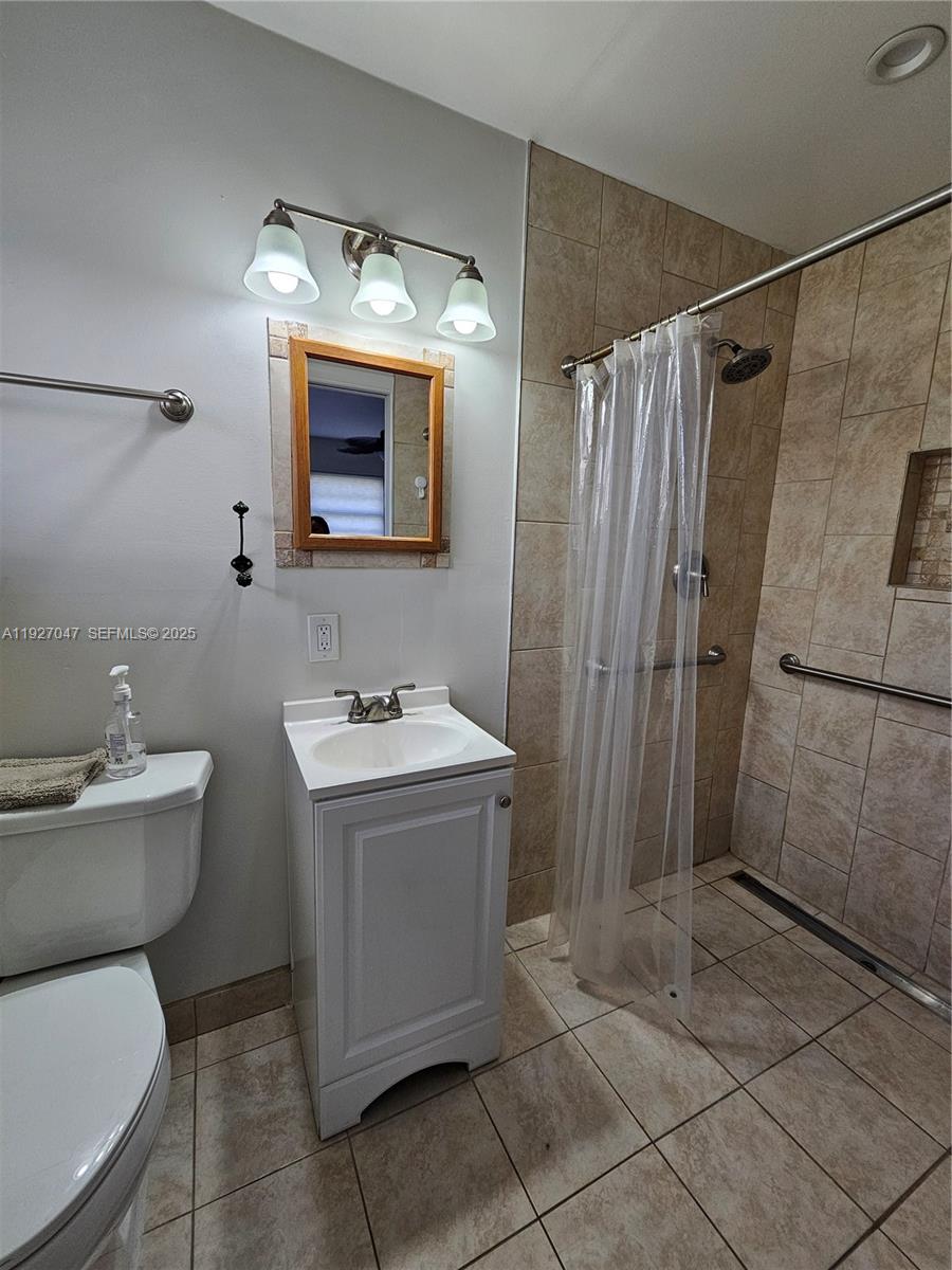 3202 Pierce Street, Unit 3202 Hollywood, FL 33021 - Photo 12 of 12 a bathroom with a sink toilet and shower