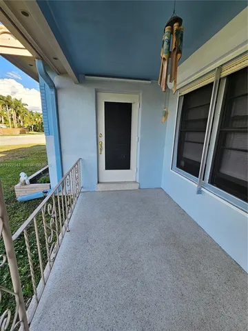 a view of a porch with wooden floor and outdoor space