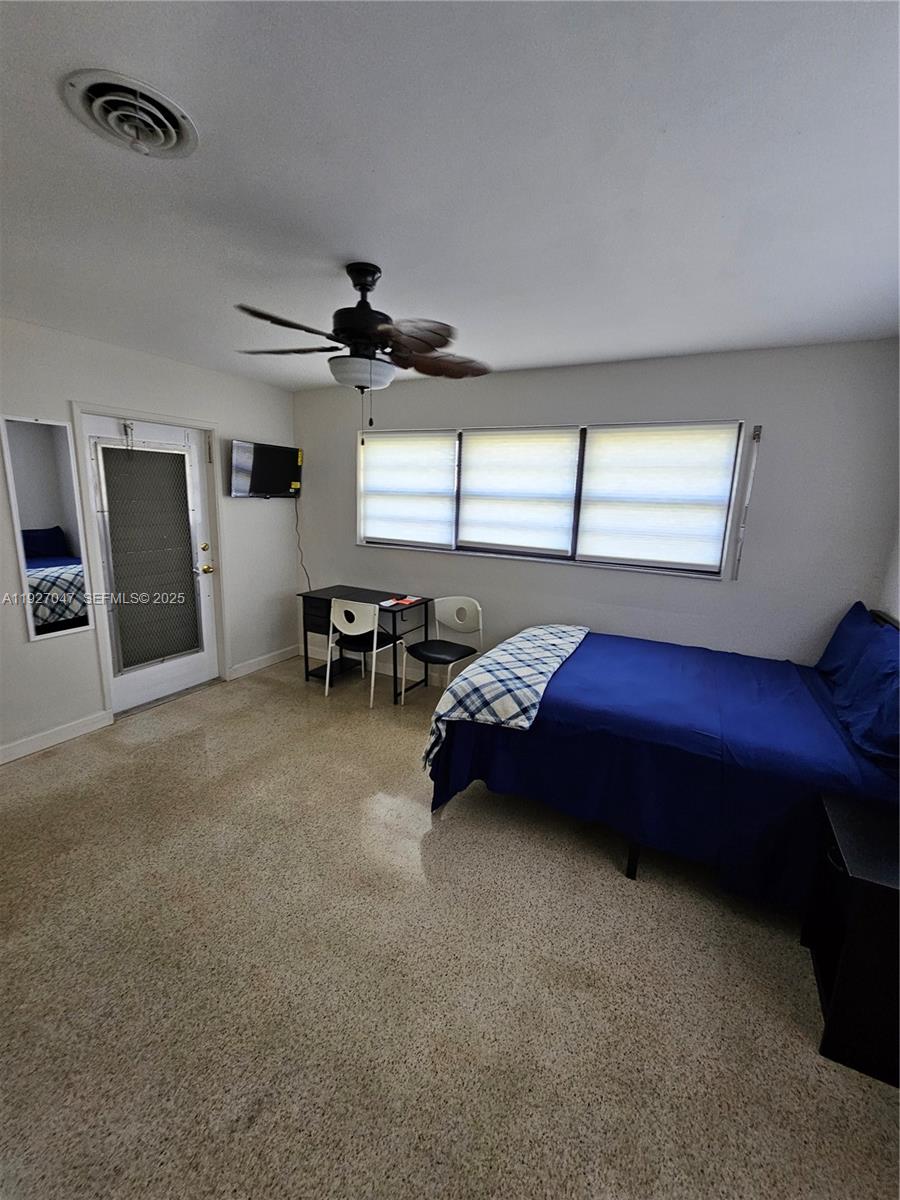 3202 Pierce Street, Unit 3202 Hollywood, FL 33021 - Photo 7 of 12 a bed room with furniture and a window