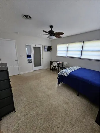 a living room with furniture and a ceiling fan