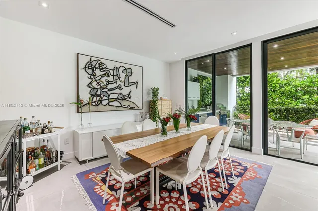 a dining room with furniture and wooden floor