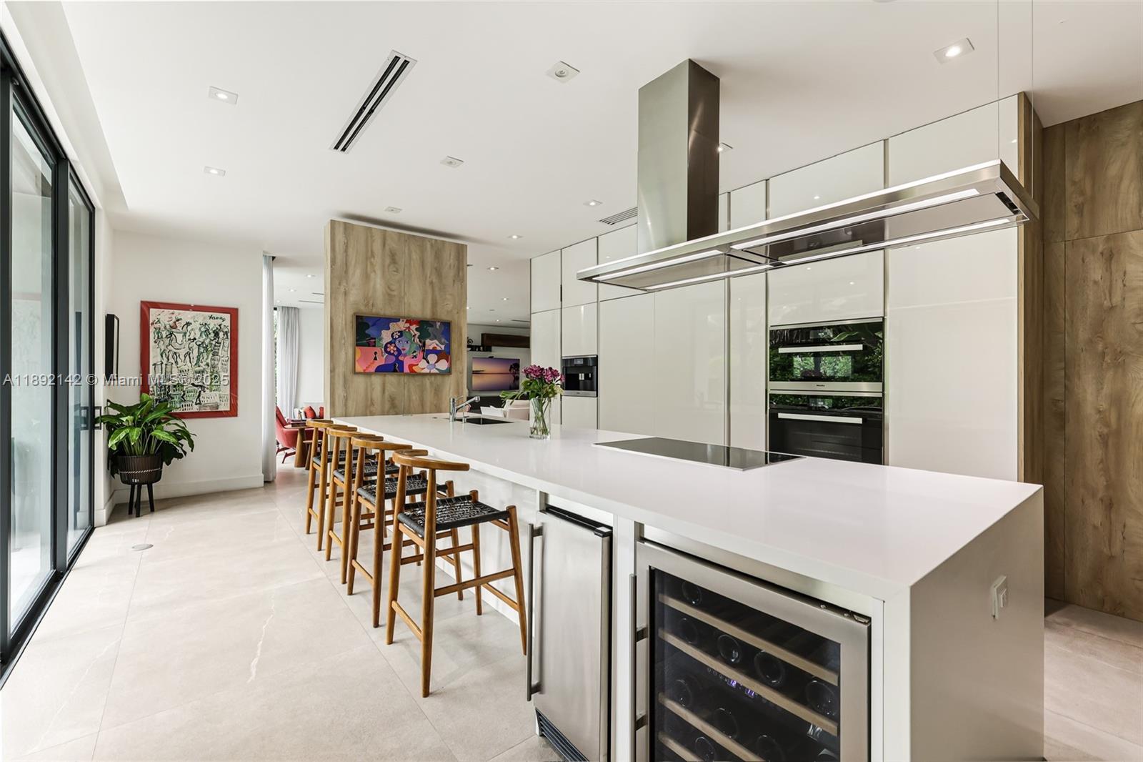 445 Ridgewood Road Key Biscayne, FL 33149 - Photo 14 of 35 a kitchen with stainless steel appliances kitchen island granite countertop a refrigerator and a stove top oven