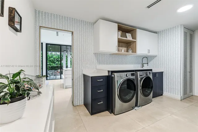 a utility room with sink dryer and washer