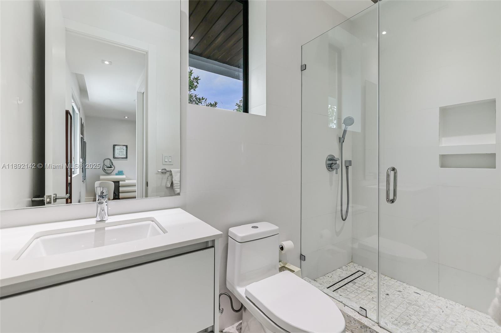 445 Ridgewood Road Key Biscayne, FL 33149 - Photo 19 of 35 a bathroom with a sink toilet and shower
