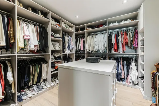 a view of walk in closet with clothes