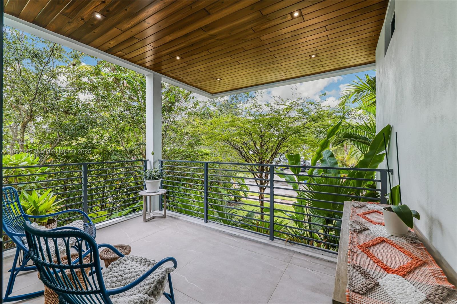 445 Ridgewood Road Key Biscayne, FL 33149 - Photo 26 of 35 a patio with table and chairs and potted plants