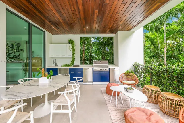 a view of a patio with table and chairs and potted plants