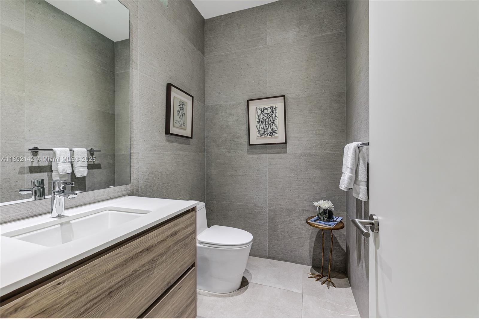 445 Ridgewood Road Key Biscayne, FL 33149 - Photo 4 of 35 a bathroom with a sink toilet and vanity