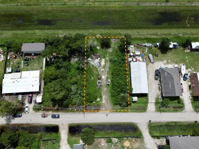 a view of building with garden space and car parked