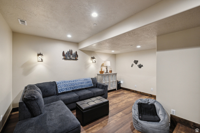 6117 North Rocky Ridge Road Peoa, UT 84061 - Photo 69 of 82 Spacious room featuring wood-finish flooring, recessed lighting, and wall sconces