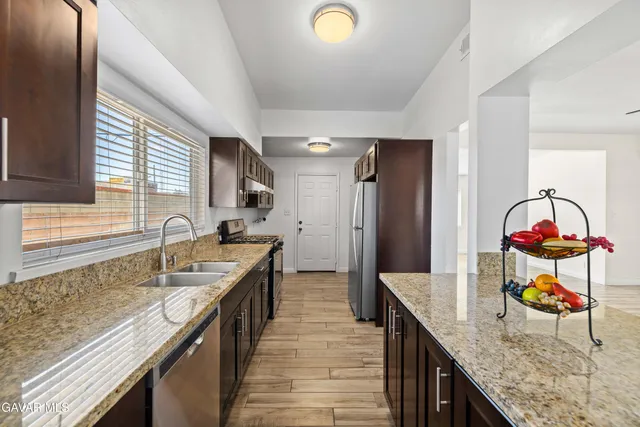 a kitchen with a sink and wooden cabinets