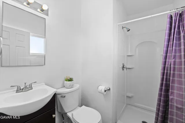 a view of a room with wooden floor and windows