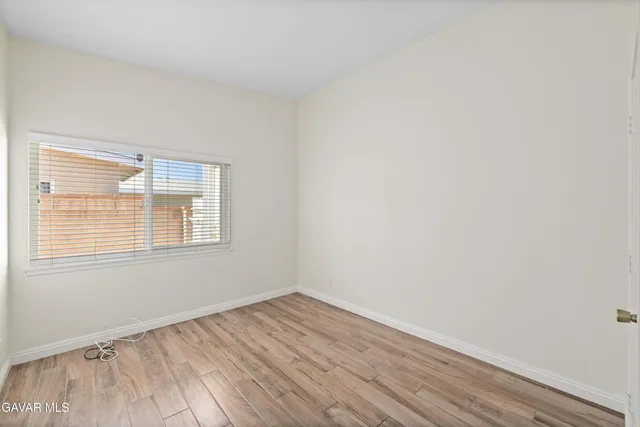 a view of an empty room and wooden floor