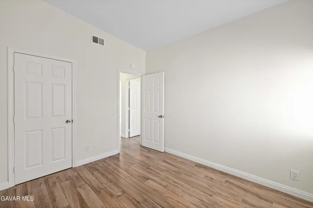 a bathroom with a granite countertop sink a toilet and a mirror