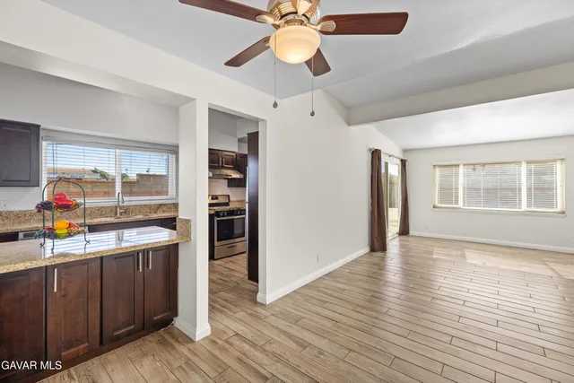 a view of a kitchen with a sink stainless steel appliances and cabinets