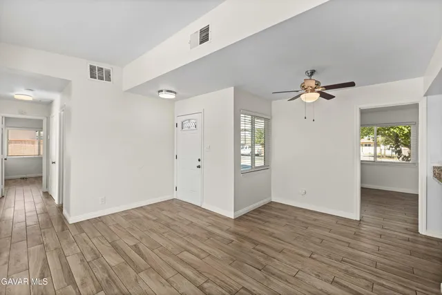 wooden floor in an empty room with a window