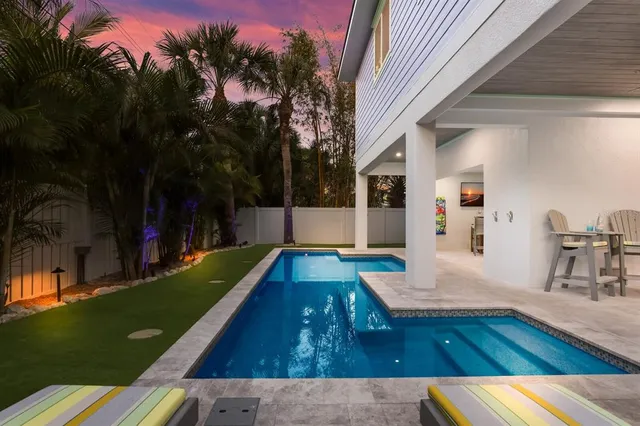 a view of a dining room with furniture a chandelier and wooden floor