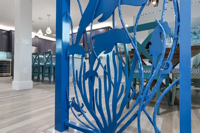 a living room with couches kitchen view and a large window