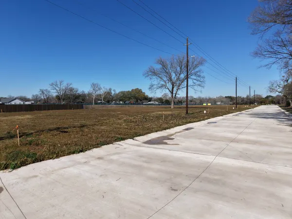 a view of swimming pool with lake and trees in the background