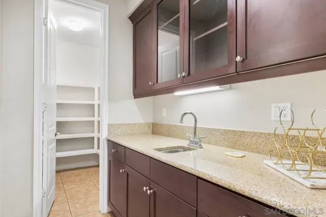 a kitchen with kitchen island granite countertop a sink stainless steel appliances and cabinets