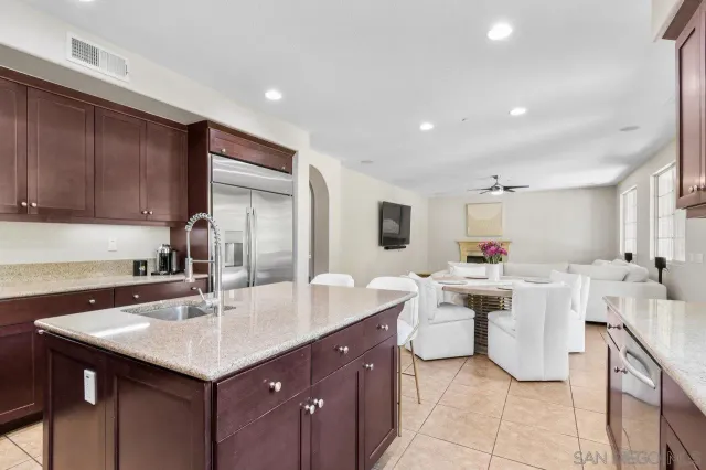 a kitchen with a sink and chairs