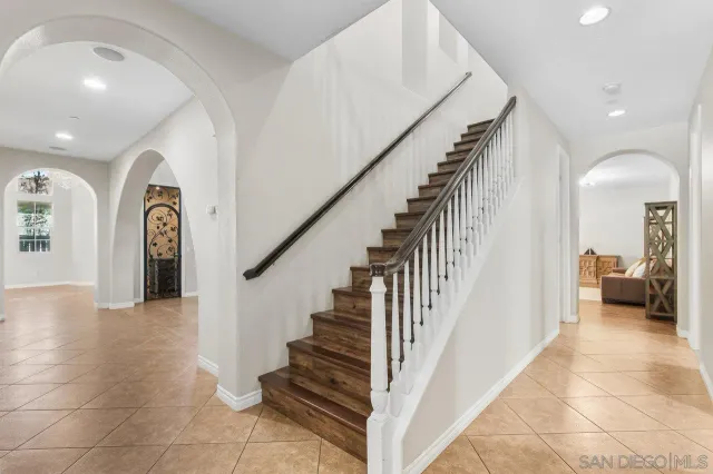 a bathroom with a granite countertop sink toilet and mirror