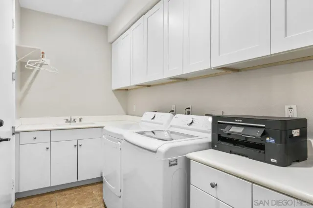 a view of a hallway with wooden floor and a ceiling fan