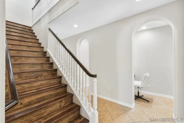 a bathroom with a granite countertop sink a toilet and a mirror