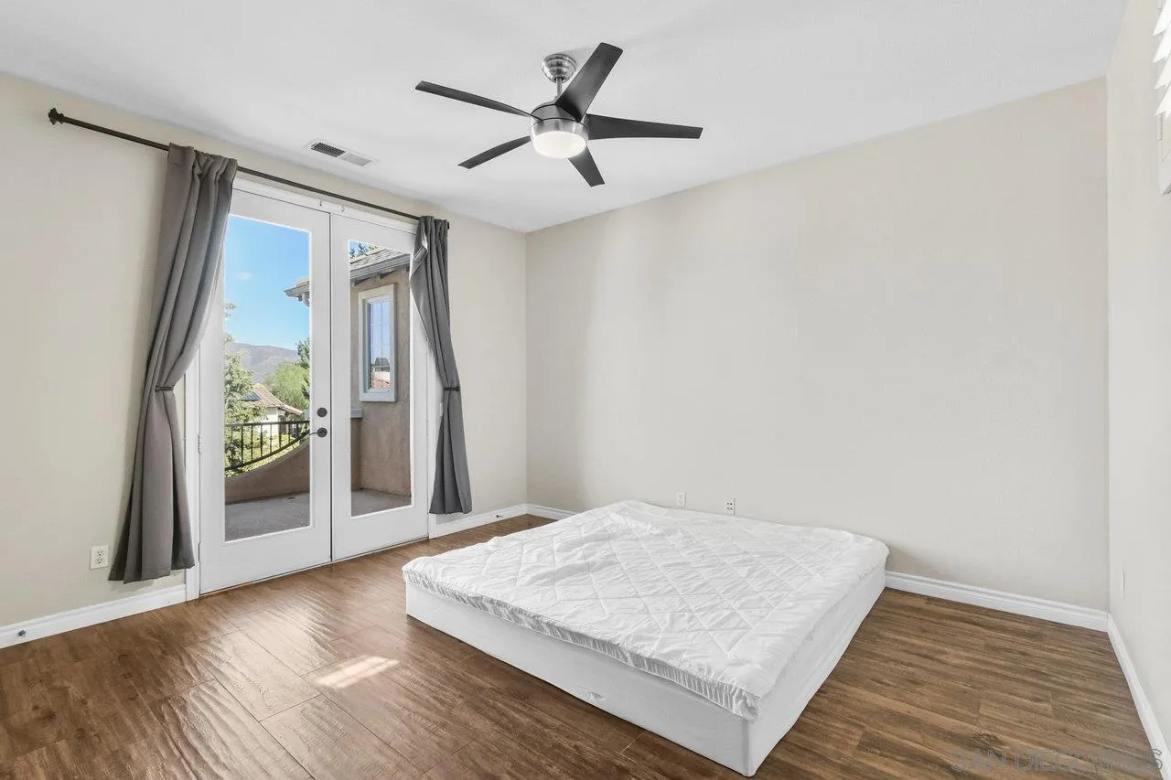2957 Ranch Gate Road Chula Vista, CA 91914 - Photo 28 of 72 a view of a hallway with wooden floor and a ceiling fan