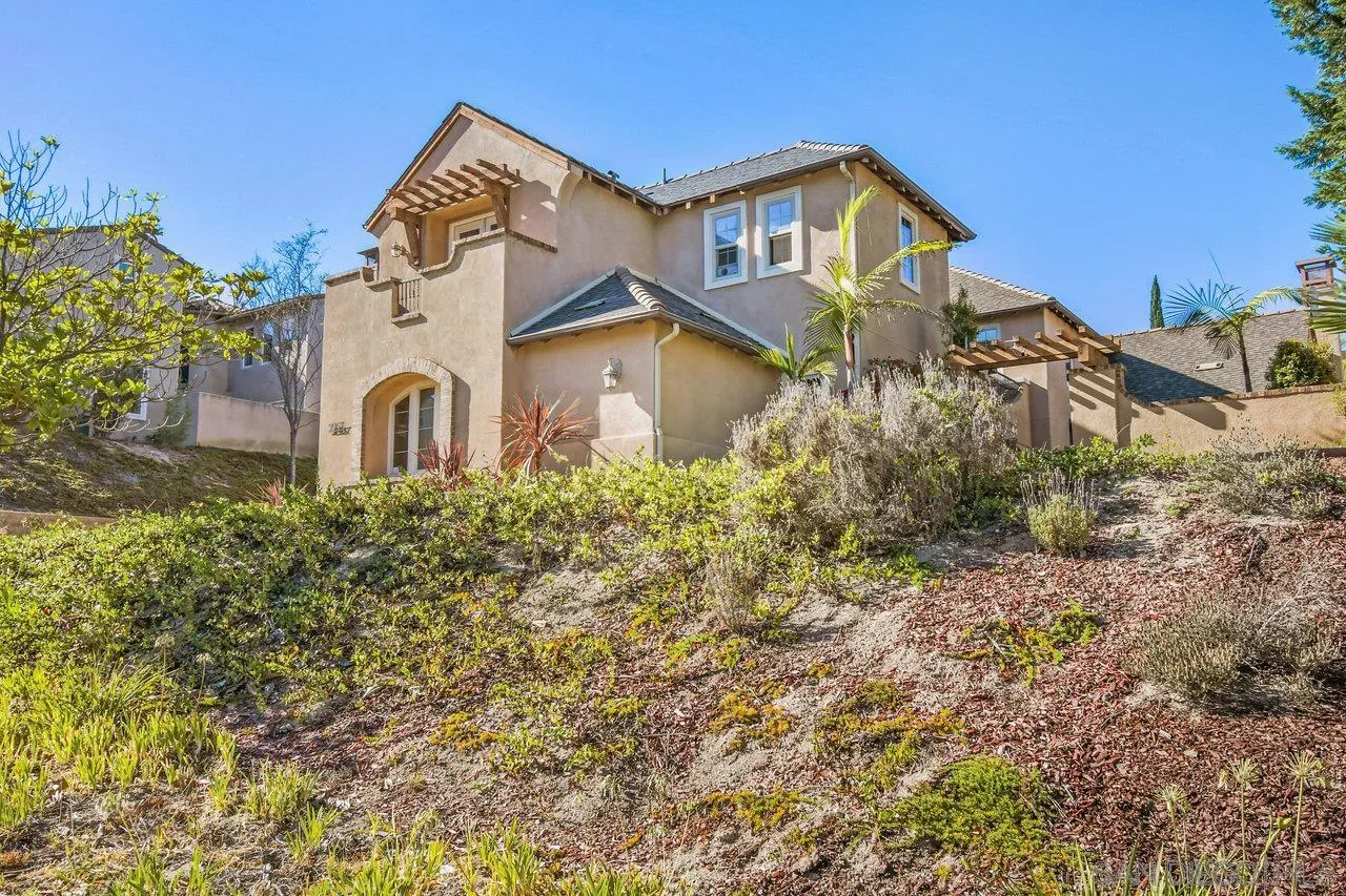 2957 Ranch Gate Road Chula Vista, CA 91914 - Photo 70 of 72 a front view of a house with a yard and balcony