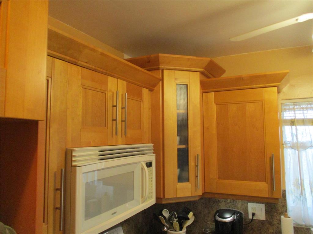 2100 Northeast 38th Street, Unit 217 Lighthouse Point, FL 33064 - Photo 16 of 28 Beautiful wooden kitchen cabinets.