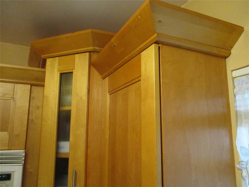 2100 Northeast 38th Street, Unit 217 Lighthouse Point, FL 33064 - Photo 17 of 28 Up close shot of the Polynesian inspired wood kitchen cabinets.