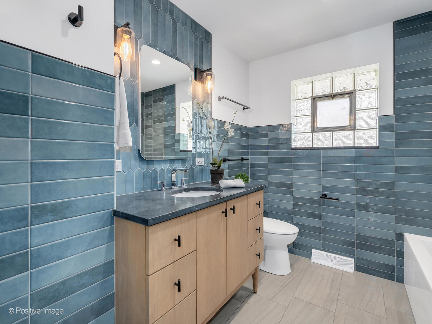 284 Blackhawk Road Riverside, IL 60546 - Photo 18 of 36 a bathroom with a granite countertop toilet a sink and a mirror