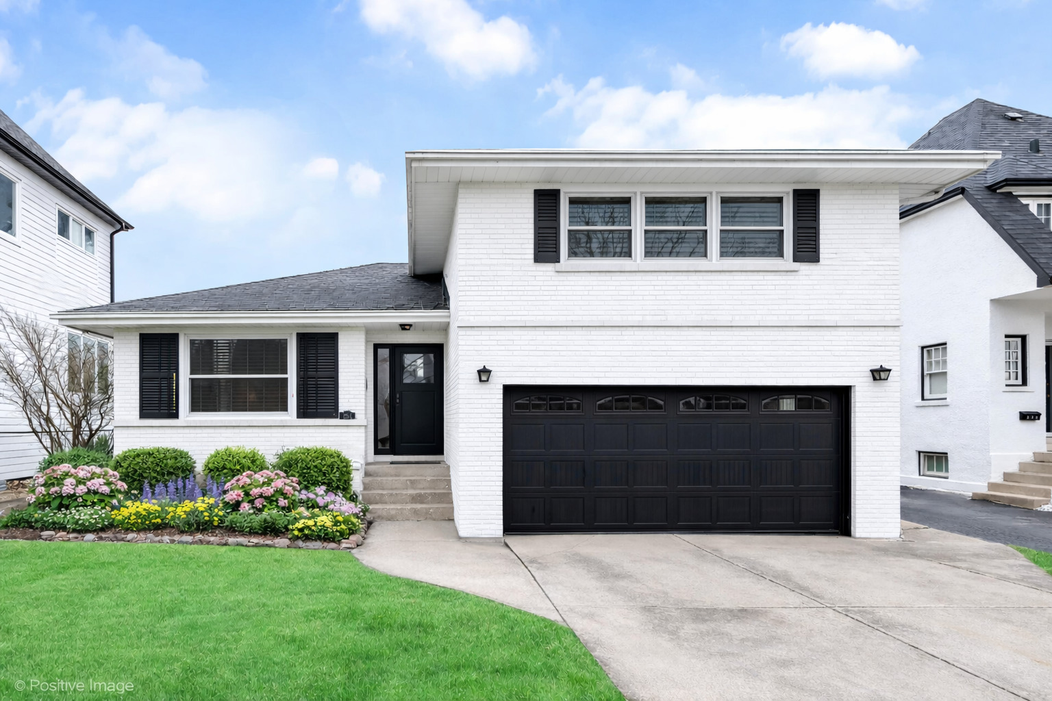 284 Blackhawk Road Riverside, IL 60546 - Photo 2 of 36 a front view of a house with a yard and garage