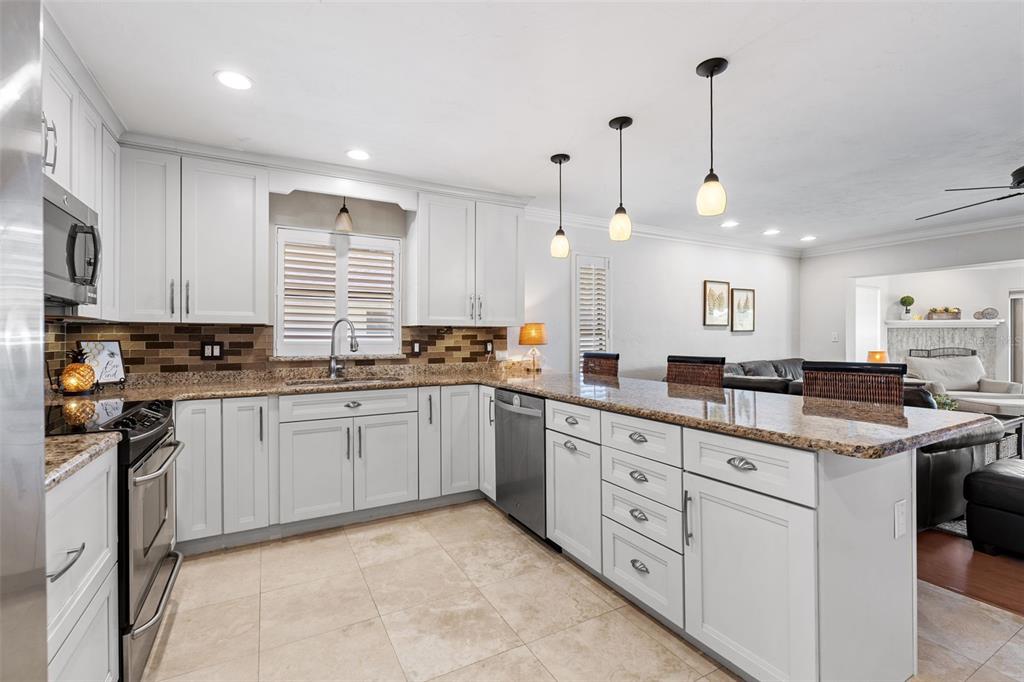 657 Riviera Bay Drive Northeast St. Petersburg, FL 33702 - Photo 11 of 50 a kitchen with white cabinets and sink